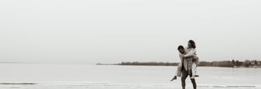 a man and a woman walking on the beach