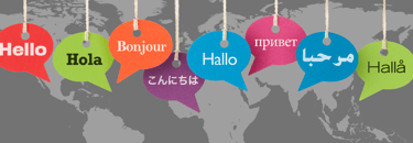 speech bubbles in different colours saying "hello" in different languages on a gray worldmap in the background