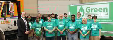 Green Homeowners United team picture, people wearing green shirts and smiling