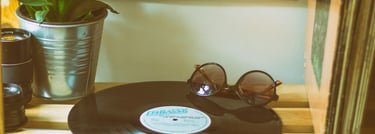 a record player vinyl album on a wooden table next to a succulent plant