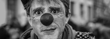 a man with a clown nose and nose paint on his face