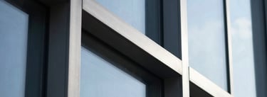 Extreme close-up of minimalist steel and glass architectural lines, sharp shadows, cool blue tones