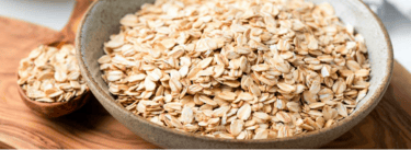 a bowl of oatmeal sitting on a cutting board