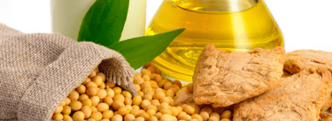 a glass of soy beans and a bottle of soy beans