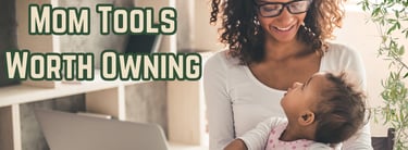 Picture of a Mom holding a baby while working on her computer