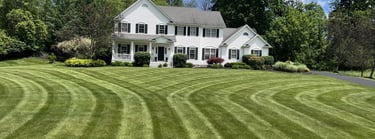 Professional lawn care services in Canandaigua, NY, featuring precision-striped grass.