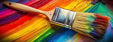 Paint brush with colors on its tip and bright colors in the background.