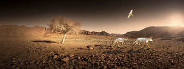 Sculpted golden antelope and soaring bird set against a panoramic desert landscape with a single tree and mountain backdrop,