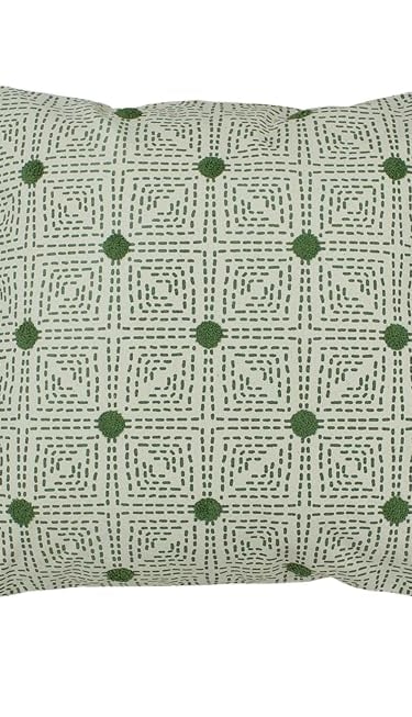 a green and white pillow with tassels and tassels