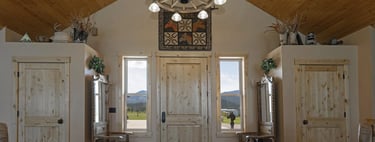 a room with a large wooden ceiling and a chandelier