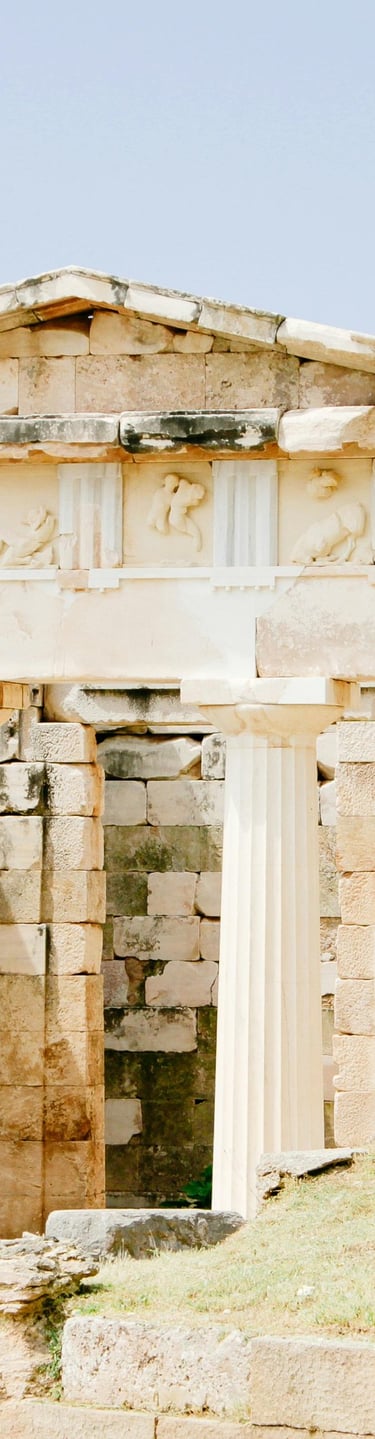 a small stone building with columns and columns