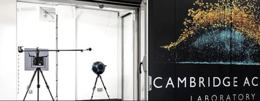 Large logo mural on black background flanked by professional audio equipment in white rooms