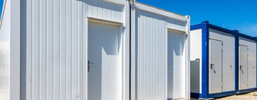 a group of three portable toilets in a desert Morocco 