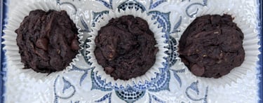 Three dairy and egg free chocolate and marrow muffins on a tray