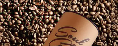 a coffee composite cup sitting on top of a pile of coffee beans