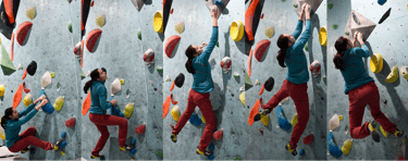 a woman doing dynamic movement on a climbing wall