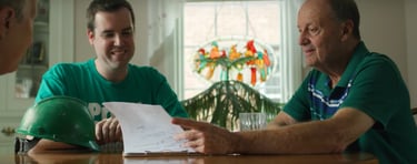 Kevin showing savings paperwork to a homeowner