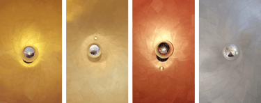 a group of three different colored lights on a wall