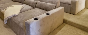 Solo Home Decor custom theater sectional with plush reclined seats, cup holders, and warm lighting