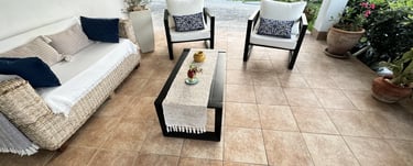 Cozy covered terrace with outdoor sofa and armchairs in beachfront villa Siracusa, Sicily