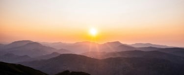 Sunrise over mountains symbolising hope, healing, guidance and finding peace after difficulties