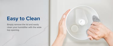 Hand wiping inside the humidifier tank with a gray cloth beside Easy to Clean text