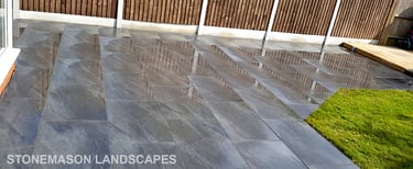 Grey sandstone circle paving slabs with charcoal edging