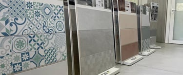 Showroom display featuring decorative pattern tiles and large ceramic wall tiles for home renovation.