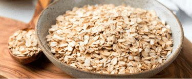 a bowl of oatmeal sitting on a cutting board