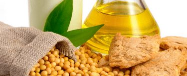a glass of soy beans and a bottle of soy beans