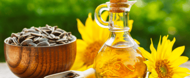 a bottle of sunflower oil with sunflowers and sunflowers