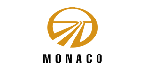 Gold Monaco RV logo featuring a road graphic inside a circle on a black background.