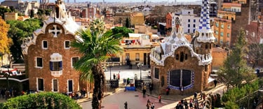 Panoramic view of Park Güell in Barcelona with Gaudi's colourful mosaic gatehouses