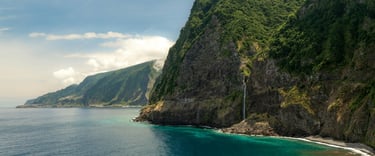 Green cliffs on Madeira Island above the Atlantic Ocean.