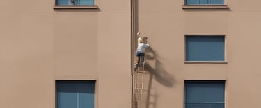 person using laptop on white wooden table