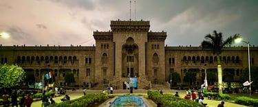 a large building with a fountain in front of it
