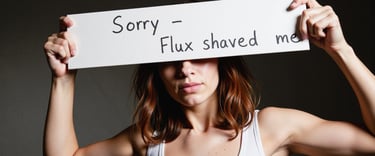 a woman holding a sign that says sorry - flux shaved me