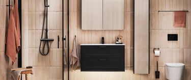 Modern bathroom with black floating vanity, walk-in shower, and vertical beige tiles.