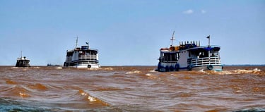 two boats are in the water near the shore