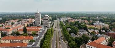 Aerial view of Wroclaw cityscape featuring the iconic sky tower skyscrapers and lush green urban architecture.