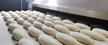Industrial bakery production line with dough processing and bread manufacturing
