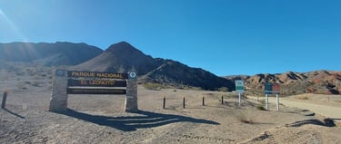a sign that says private parking lot in front of a mountain