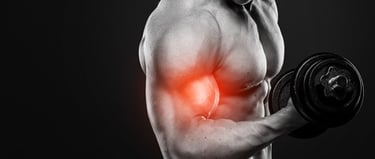 Muscular bodybuilder performing a dumbbell bicep curl with a red highlight on the muscle for fitness training.
