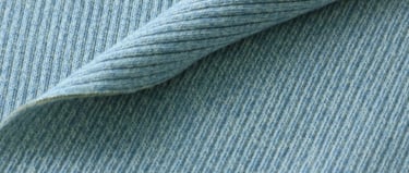 a close up of a blue and white ribbing fabric