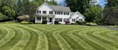 Professional lawn care services in Canandaigua, NY, featuring precision-striped grass.