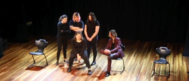 a group of people standing around a man on a stage