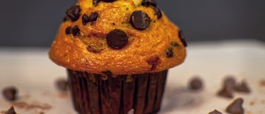 a chocolate chip muffin with chocolate chips on the side