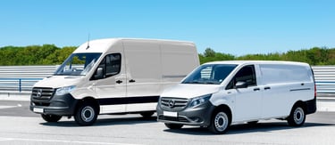 two vans parked in a parking lot