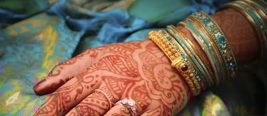 a woman's hands with hennakes and rings