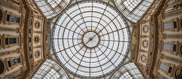 Iron framework and glass vaults curve gracefully, supporting the arcade’s luminous daylight structure designed by G. Mengoni.